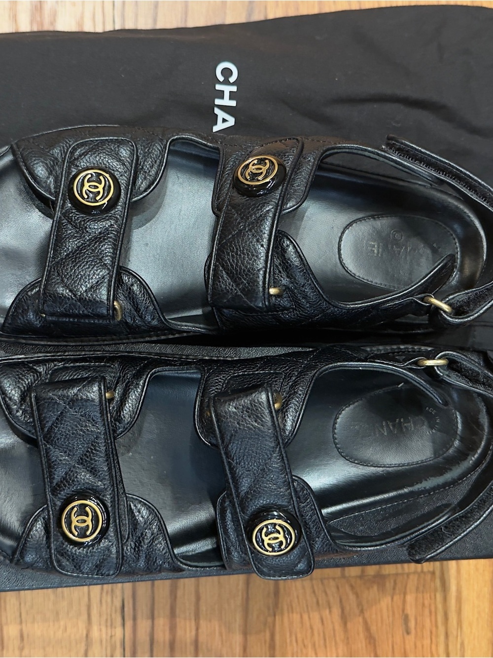 CHANEL Black Leather Sandals with Gold Logo Details